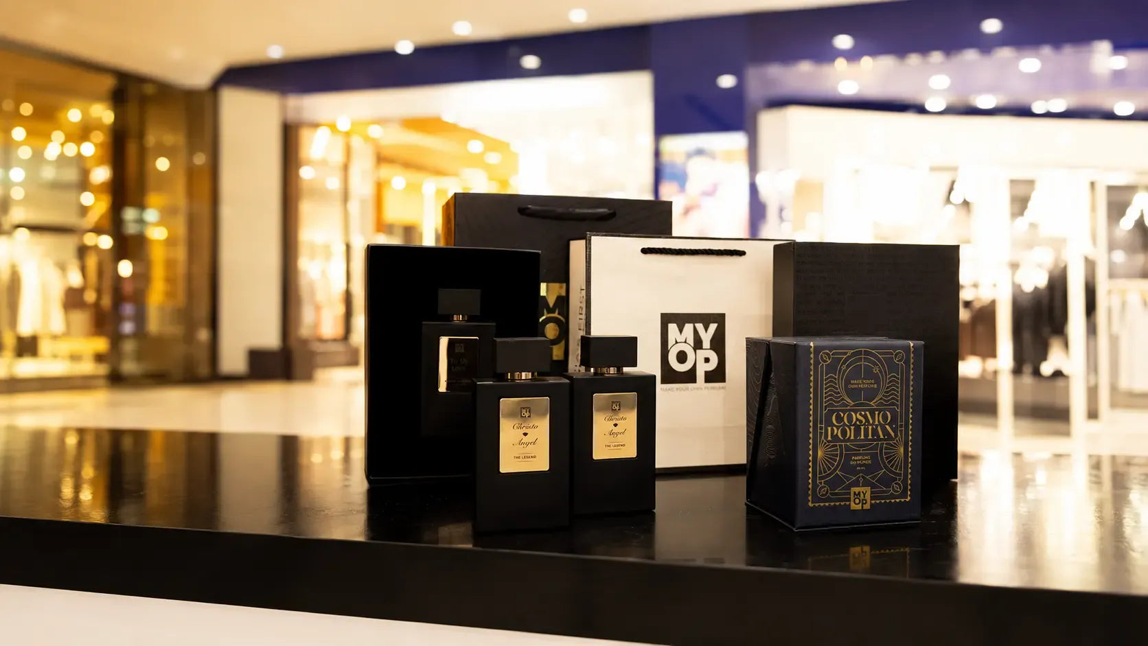Niche perfume bottle next to a designer perfume bottle, comparing fragrance concentration and design